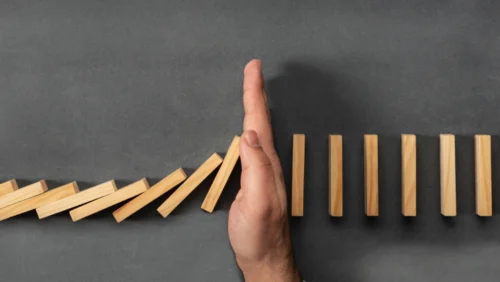 hand in the middle of beige dominos